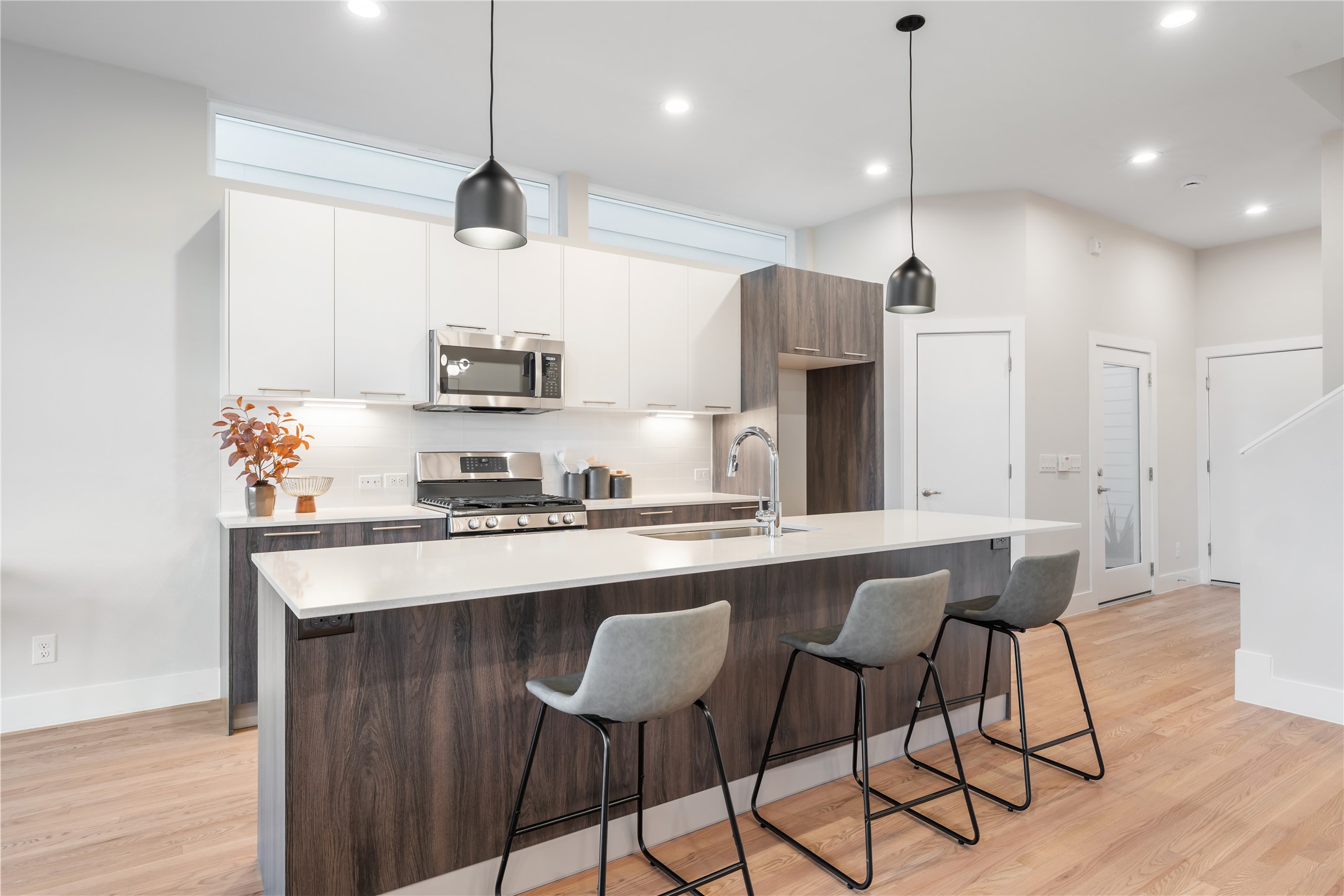 1912 Erastus Street Houston, TX 77020 - Photo 3 of 29 The oversized island comfortably seats four, illuminated by custom pendant lighting that adds a warm, modern touch to the heart of the home.