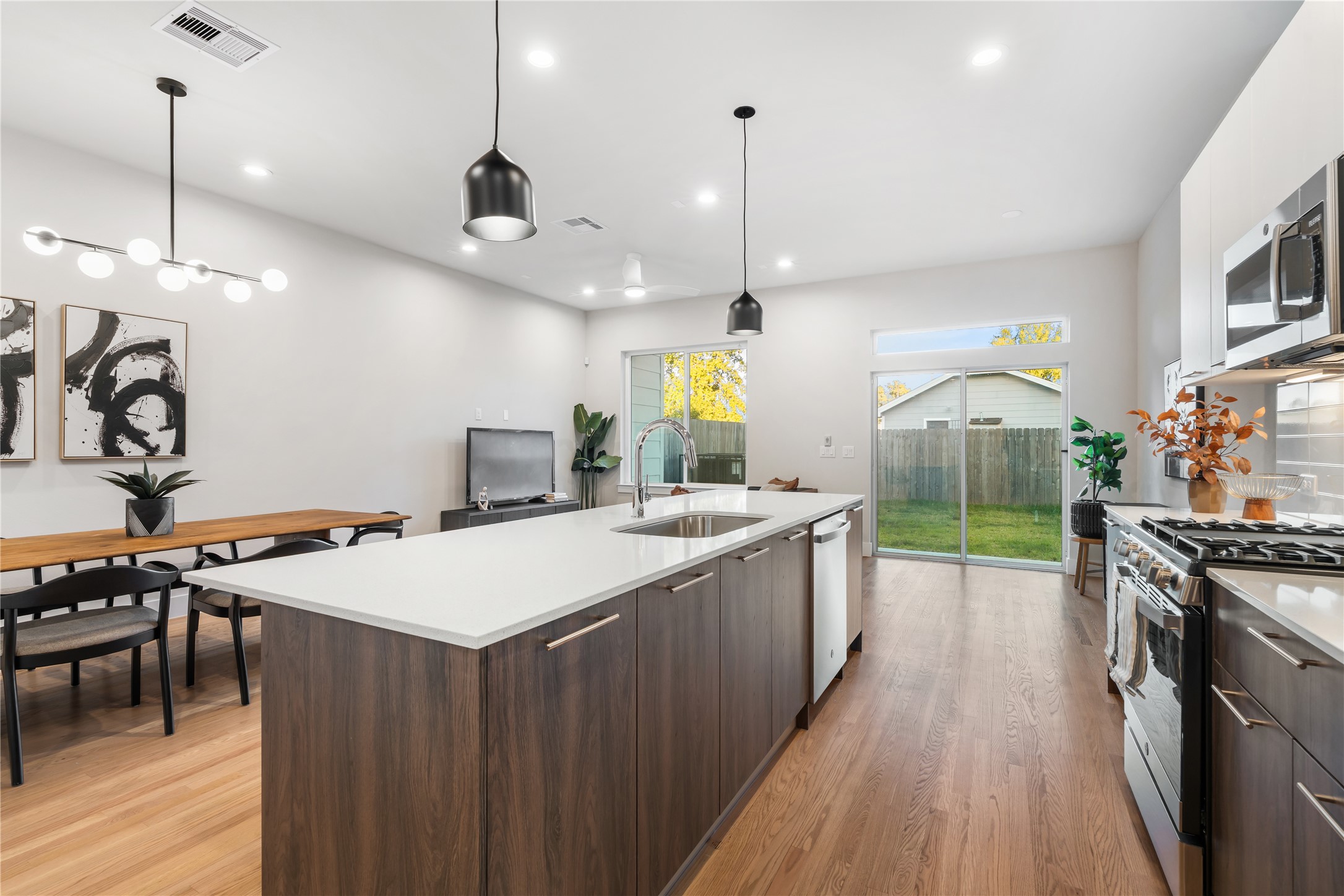 1912 Erastus Street Houston, TX 77020 - Photo 7 of 29 Sunlight pours in through the large windows & sliding glass doors, creating a bright, inviting atmosphere that extends to your covered patio.