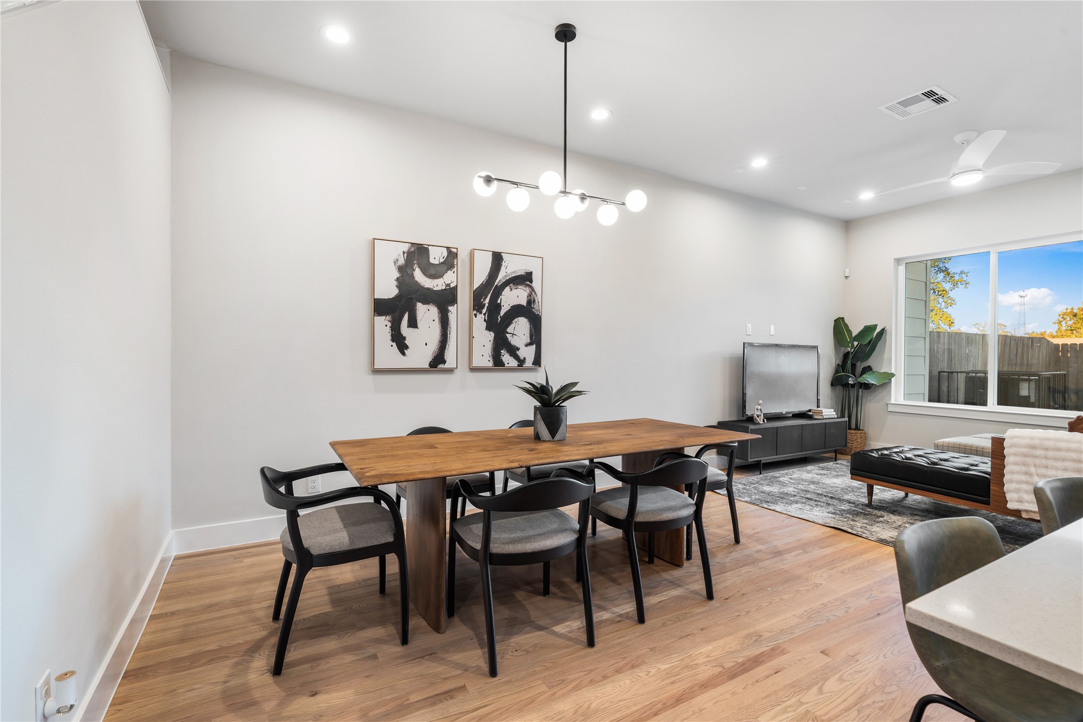 1912 Erastus Street Houston, TX 77020 - Photo 8 of 29 The dining area comfortably seats six, framed by clean lines, warm hardwood floors & contemporary lighting.
