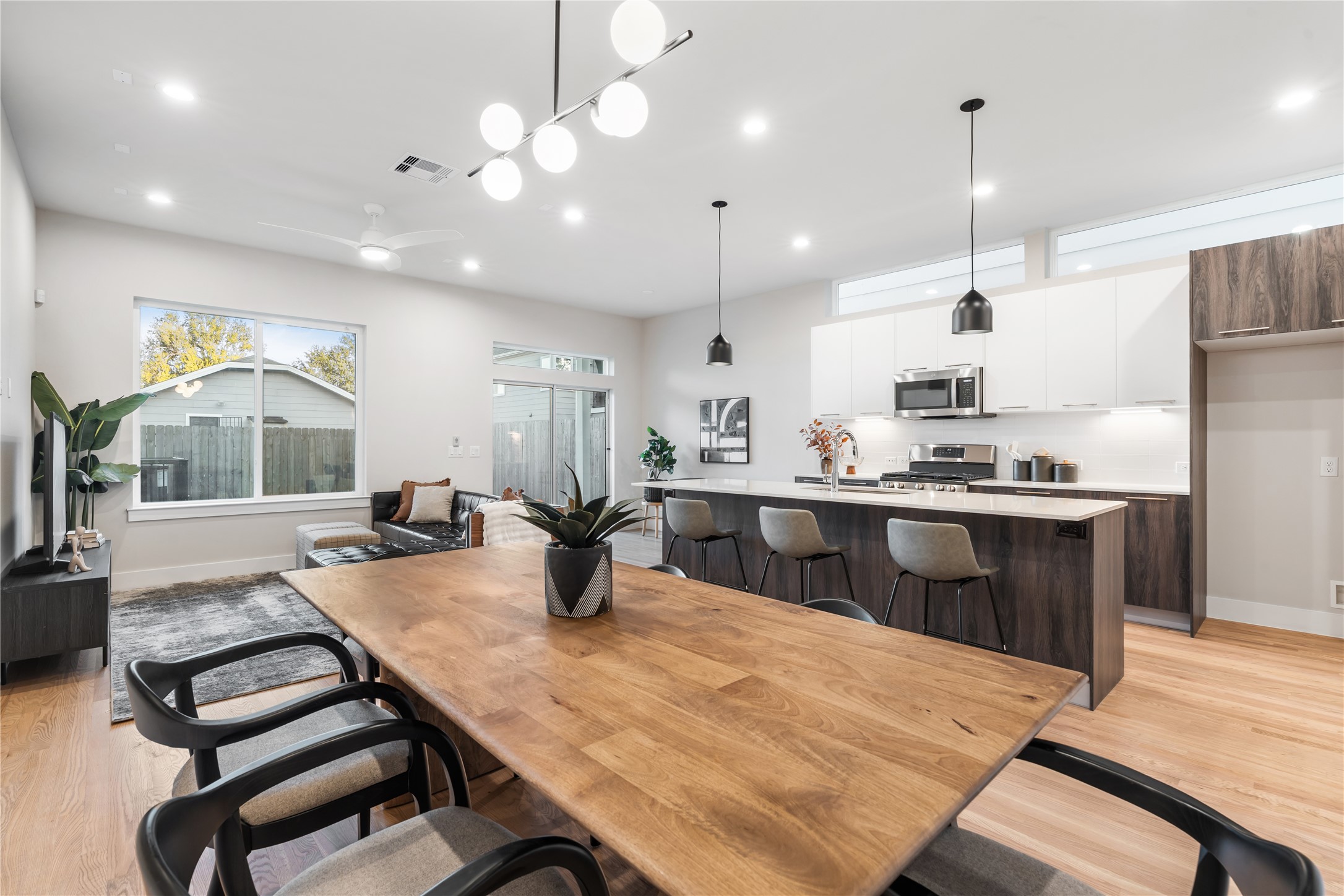 1912 Erastus Street Houston, TX 77020 - Photo 9 of 29 A view of the main living area from the dining room showcases the home’s open-concept design, where natural light, modern finishes & thoughtful flow create a seamless everyday living experience.