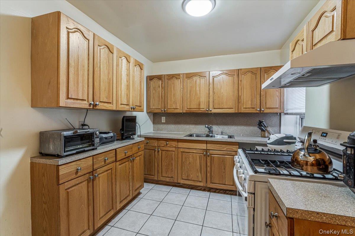 144-60 Gravett Road, Unit 6F Queens, NY 11367 - Photo 15 of 20 a kitchen with stainless steel appliances granite countertop a stove a sink dishwasher and a refrigerator