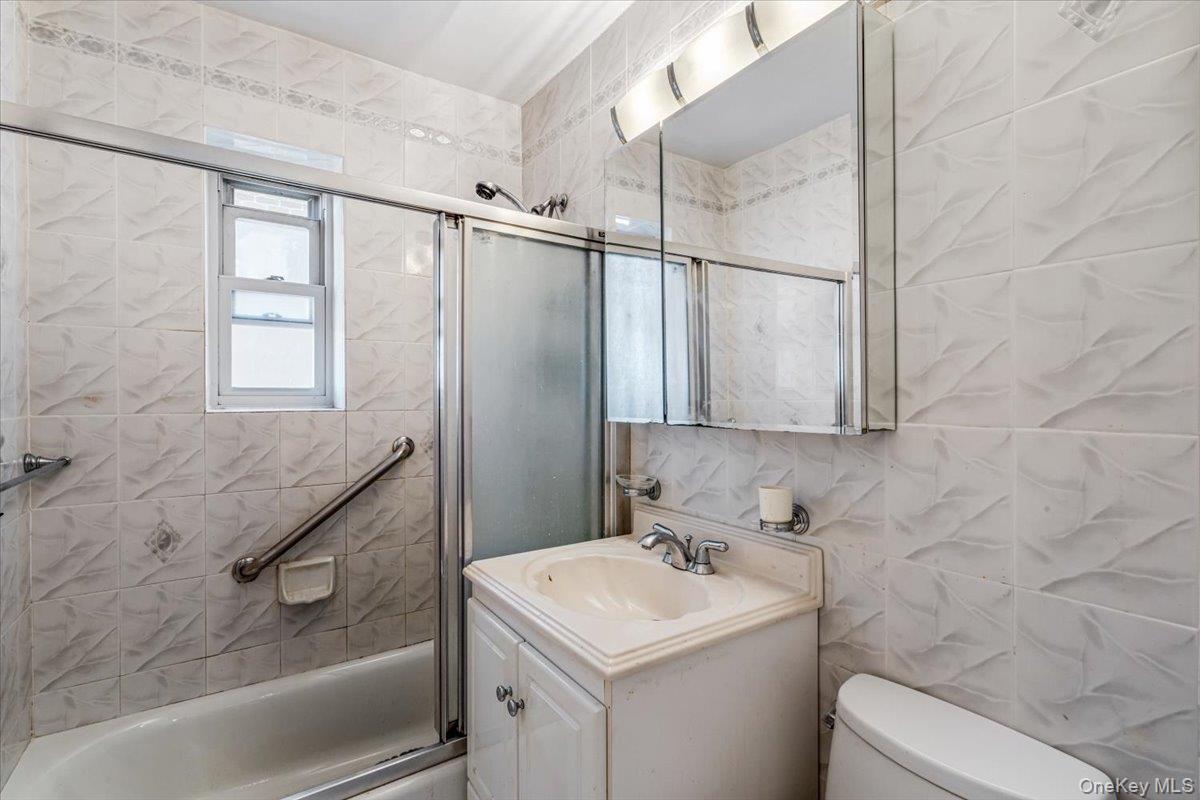 144-60 Gravett Road, Unit 6F Queens, NY 11367 - Photo 17 of 20 a bathroom with a sink toilet and shower