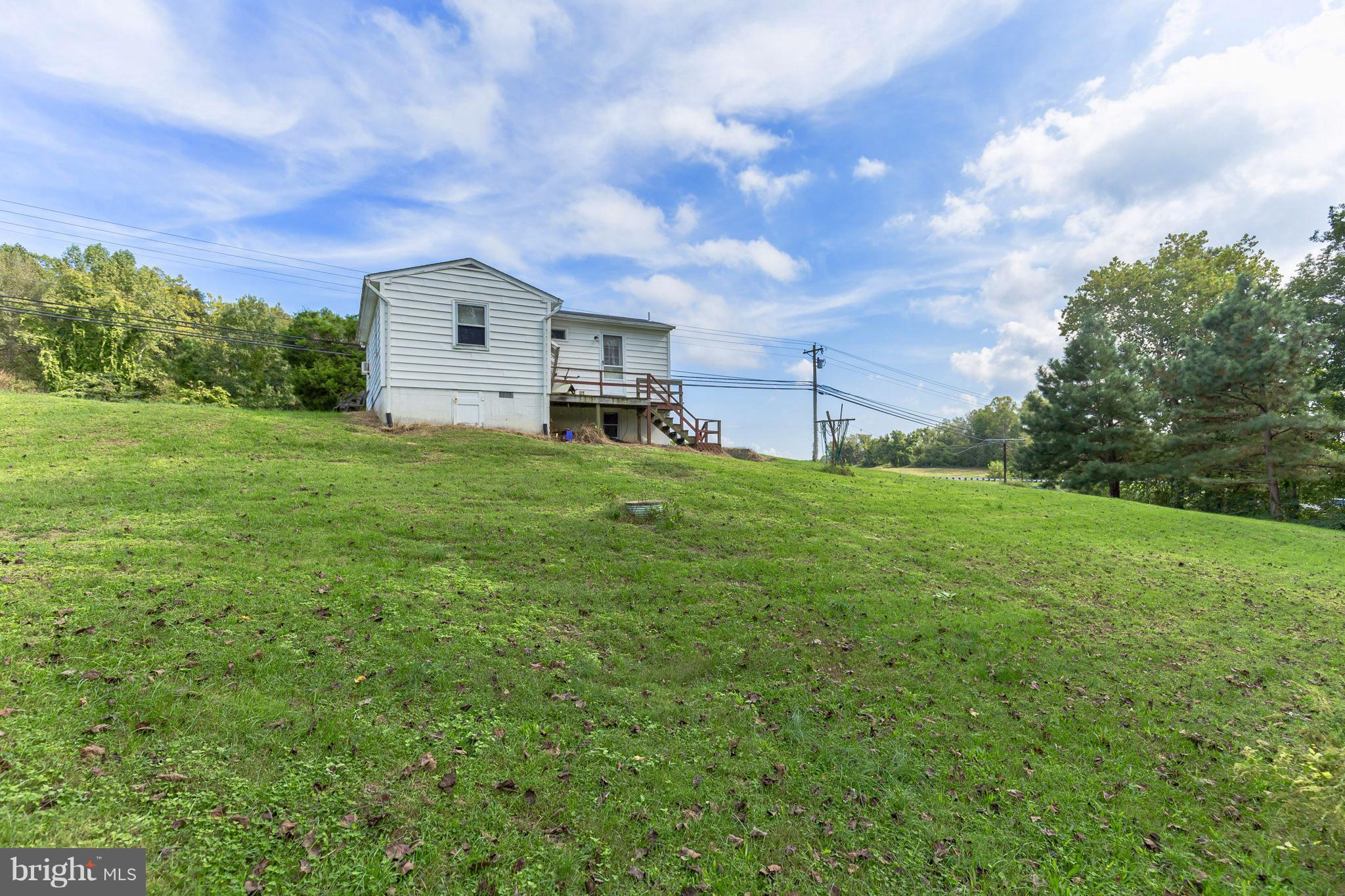 2730 Solomons Island Road Huntingtown, MD 20639 - Photo 2 of 22 a backyard of a house with table and chairs