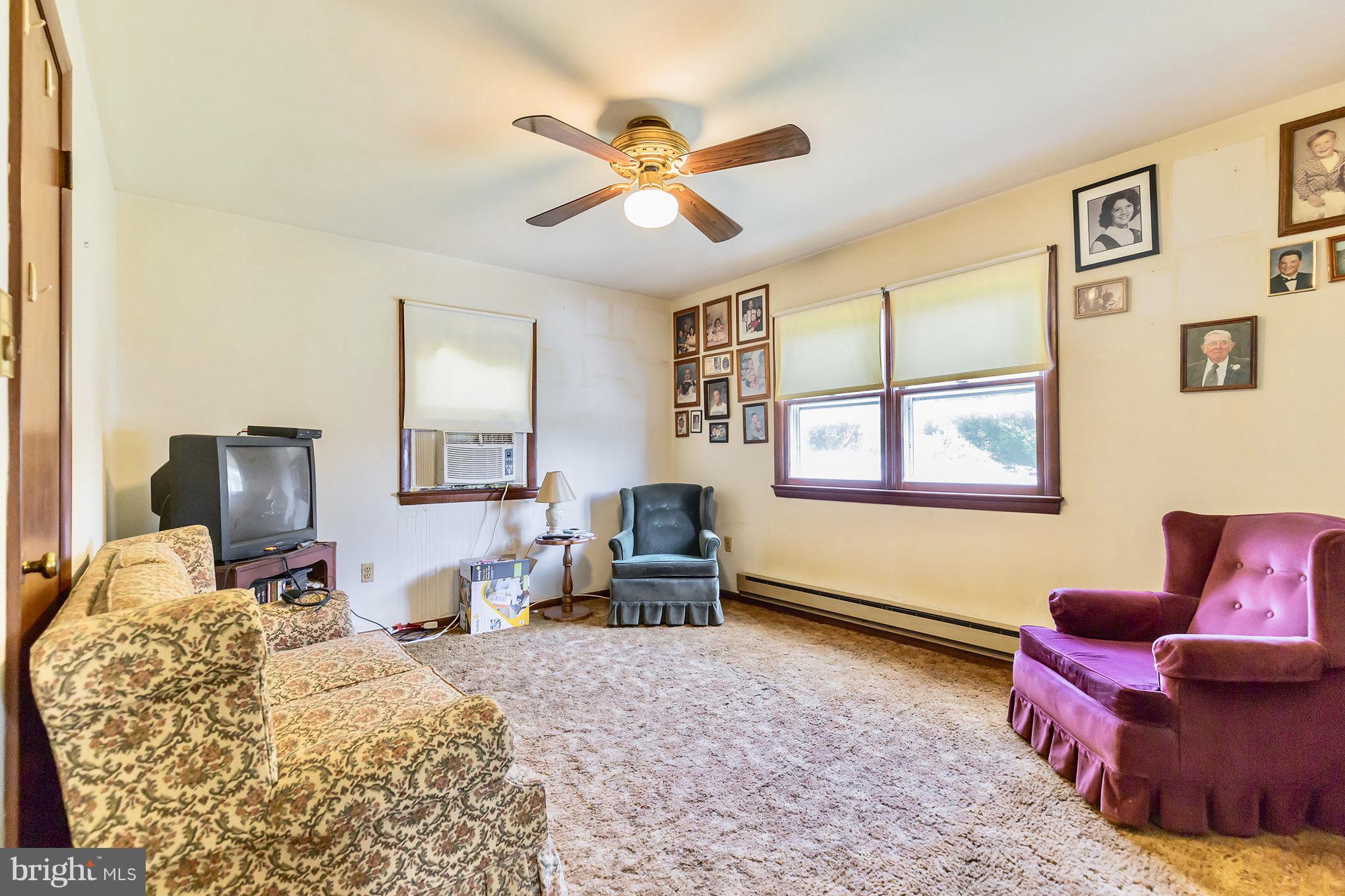 2730 Solomons Island Road Huntingtown, MD 20639 - Photo 12 of 22 a bedroom with a bed and wooden floor