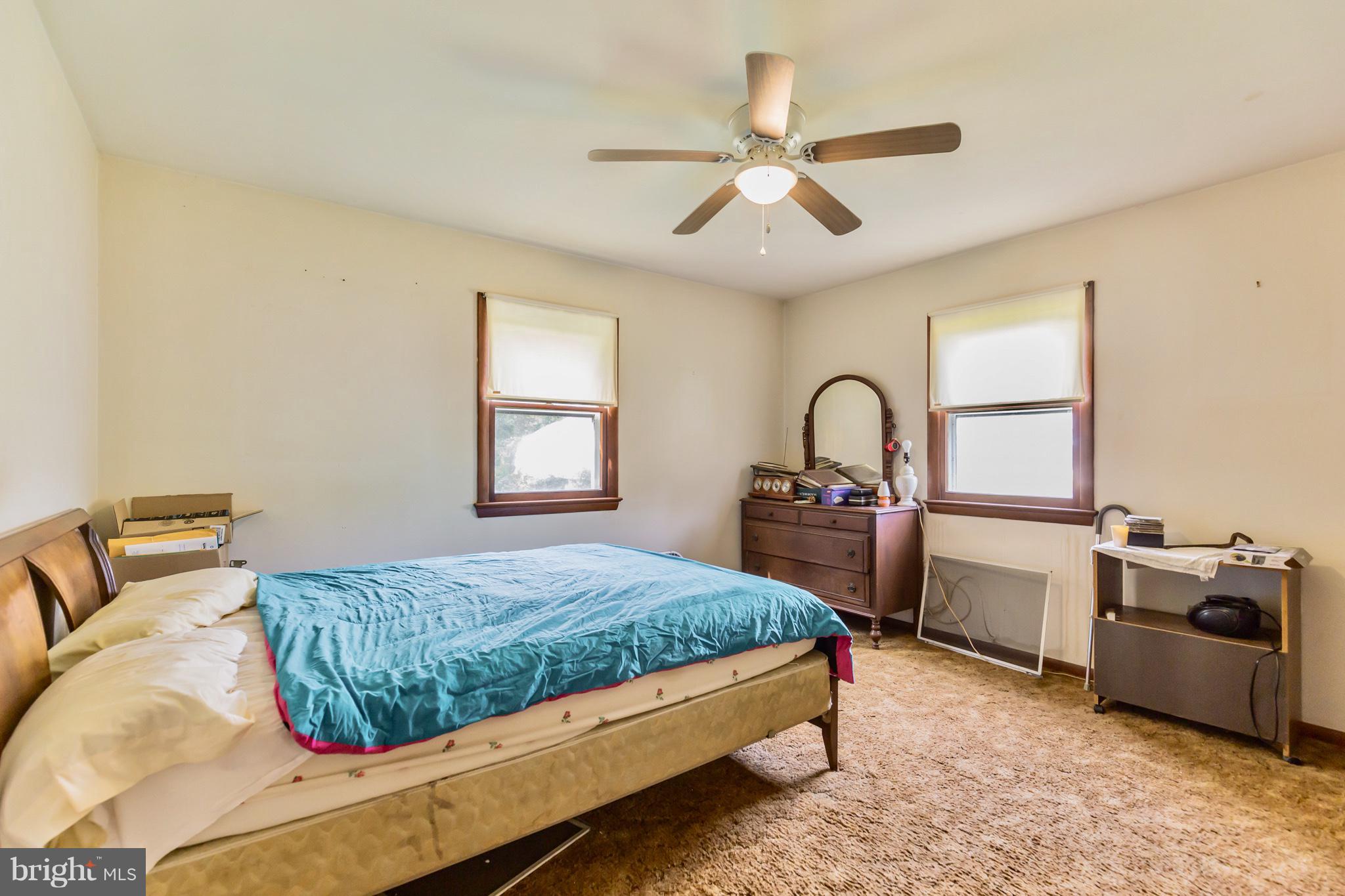 2730 Solomons Island Road Huntingtown, MD 20639 - Photo 14 of 22 a bedroom with a bed dresser and a window