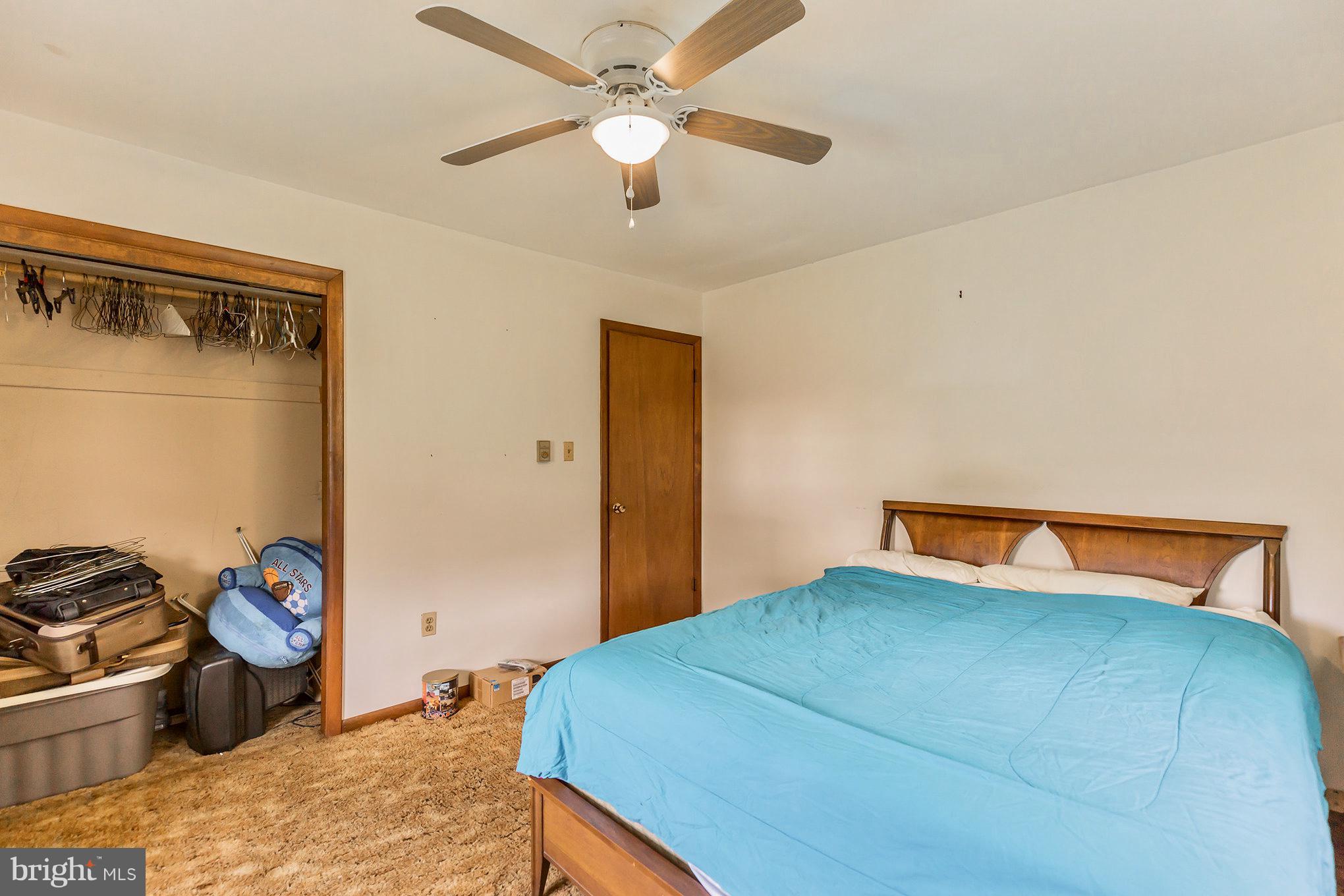 2730 Solomons Island Road Huntingtown, MD 20639 - Photo 16 of 22 a bedroom with a bed and a chandelier