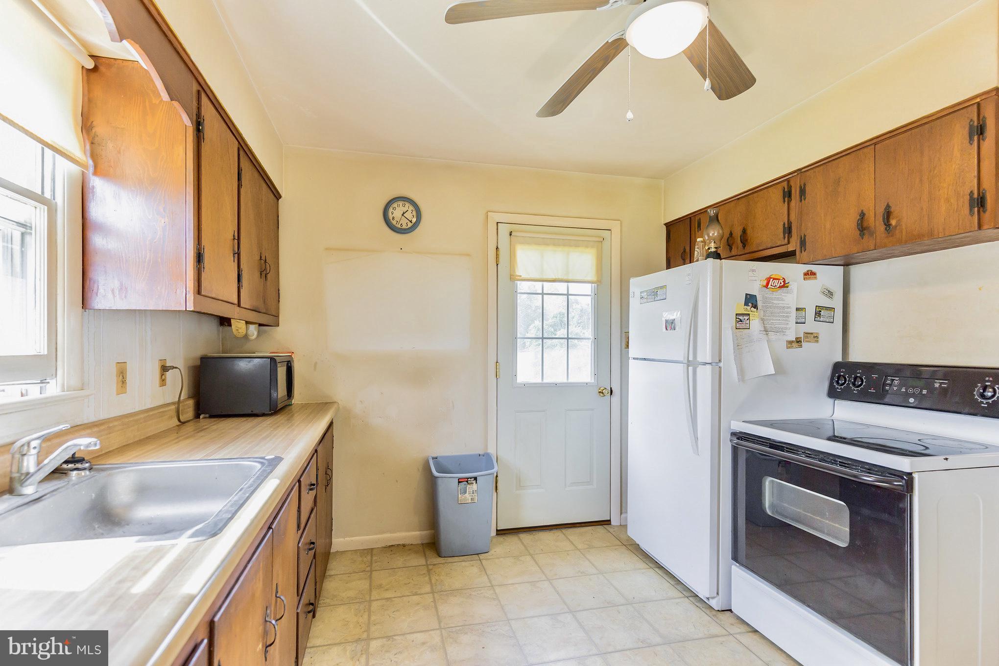 2730 Solomons Island Road Huntingtown, MD 20639 - Photo 9 of 22 a kitchen with a sink stove and refrigerator