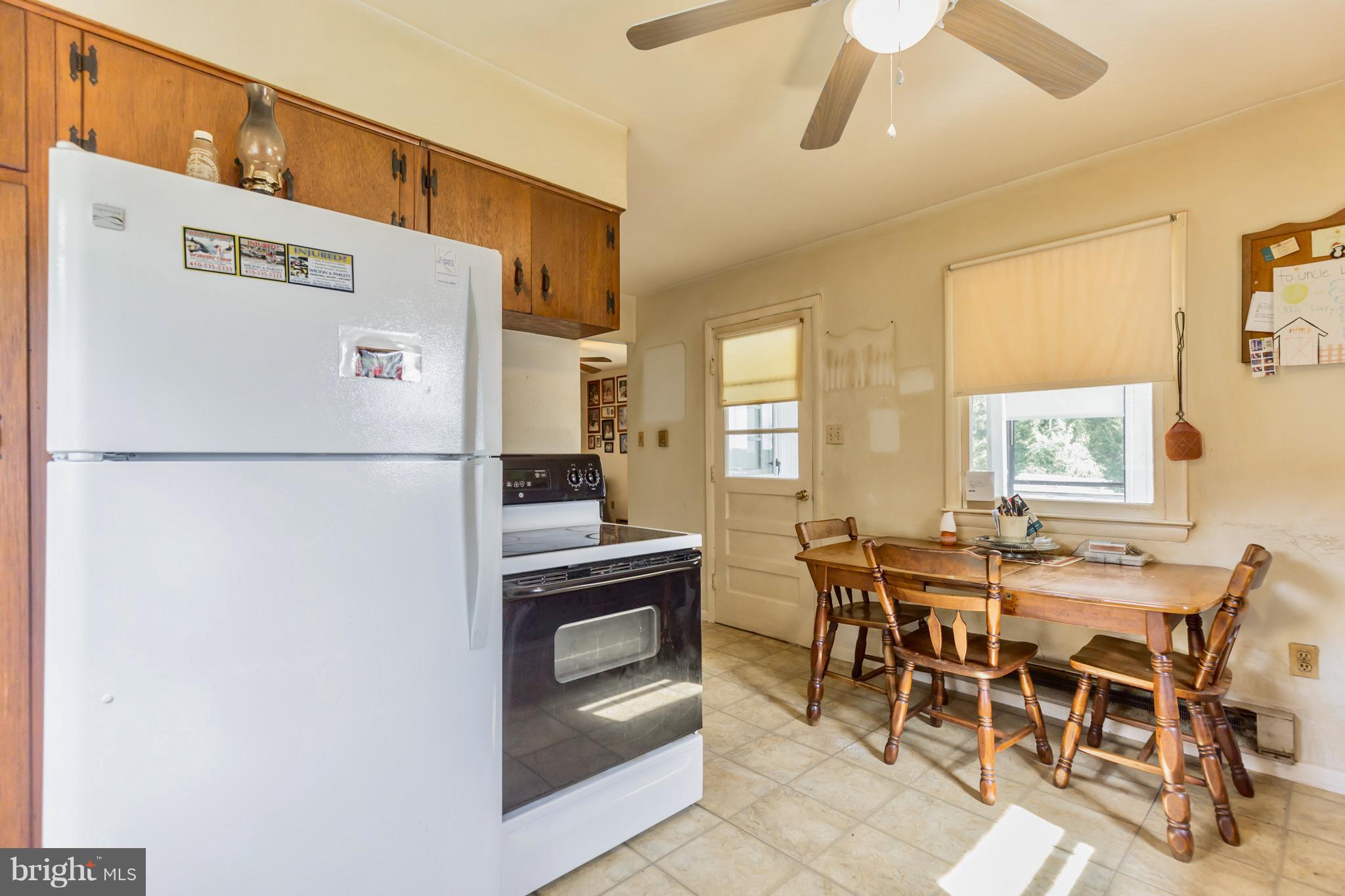 2730 Solomons Island Road Huntingtown, MD 20639 - Photo 10 of 22 a kitchen with stainless steel appliances a refrigerator and a dining table