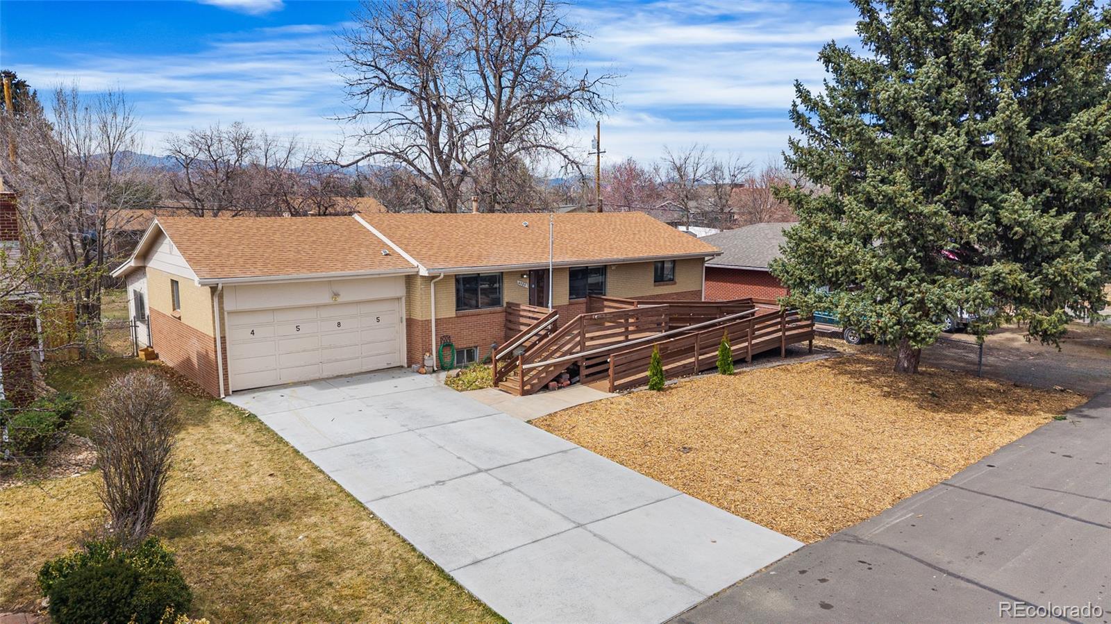 4585 Garland Street Wheat Ridge, CO 80033 - Photo 1 of 35 a view of a backyard with chairs and a stove