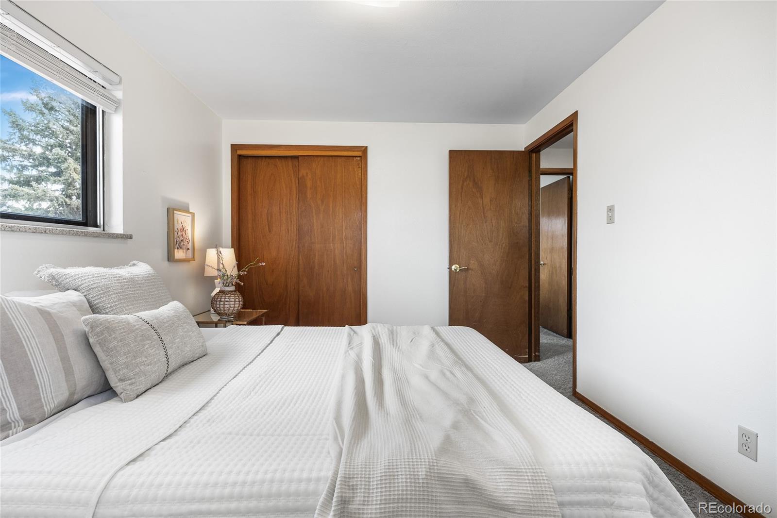 4585 Garland Street Wheat Ridge, CO 80033 - Photo 15 of 35 a bedroom with a bed and a painting on the wall