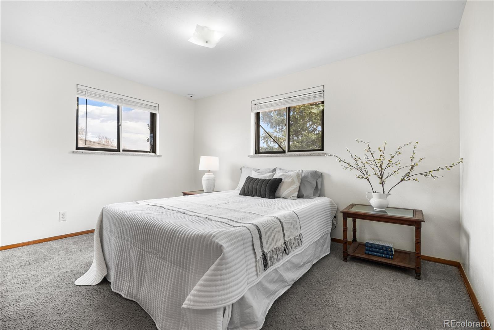4585 Garland Street Wheat Ridge, CO 80033 - Photo 17 of 35 a bedroom with a bed and a painting on the wall