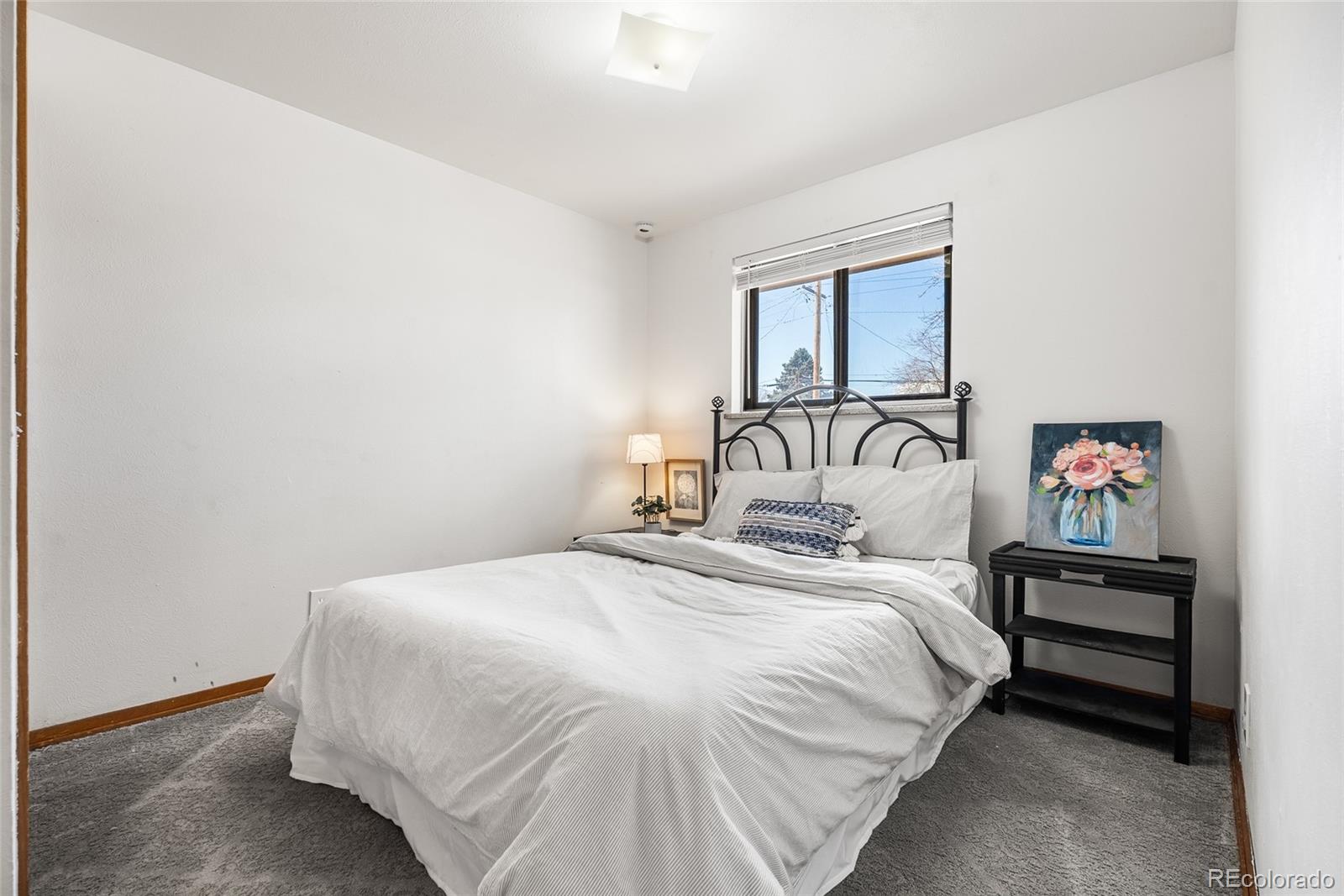 4585 Garland Street Wheat Ridge, CO 80033 - Photo 18 of 35 a bedroom with a bed and a window
