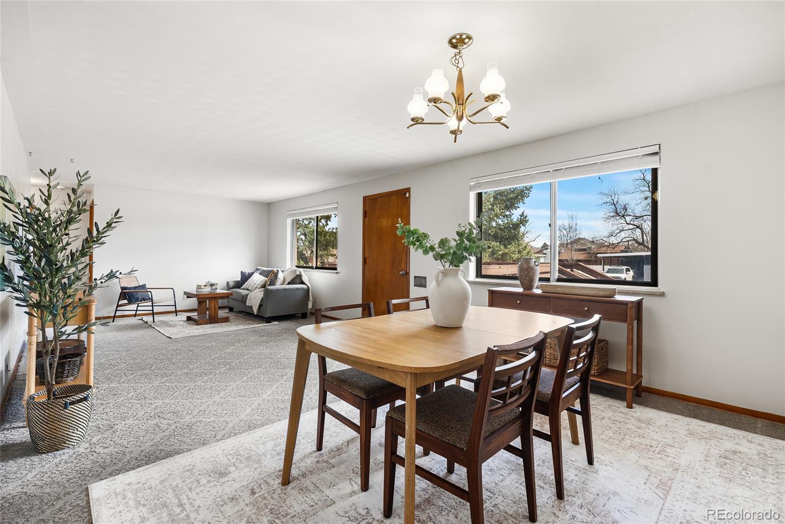 4585 Garland Street Wheat Ridge, CO 80033 - Photo 2 of 35 a view of a dining room with furniture window and wooden floor