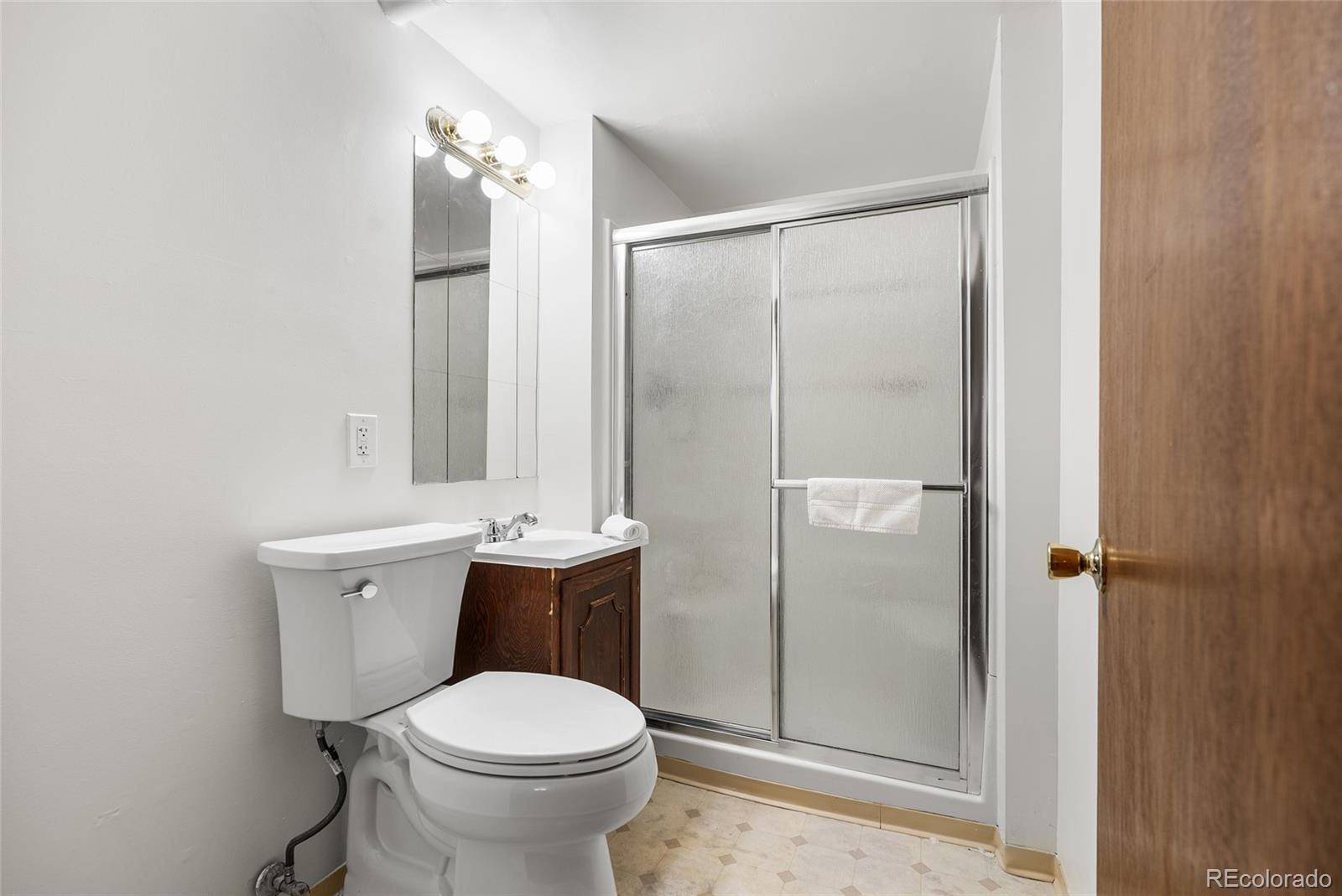 4585 Garland Street Wheat Ridge, CO 80033 - Photo 24 of 35 a bathroom with a toilet sink and shower