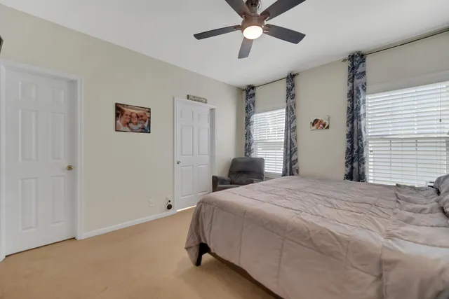 a bedroom with a large bed and a chandelier