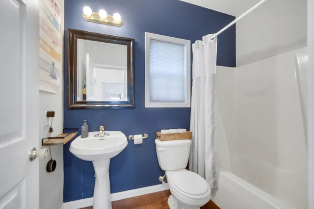 a white toilet sitting next to a bathroom sink
