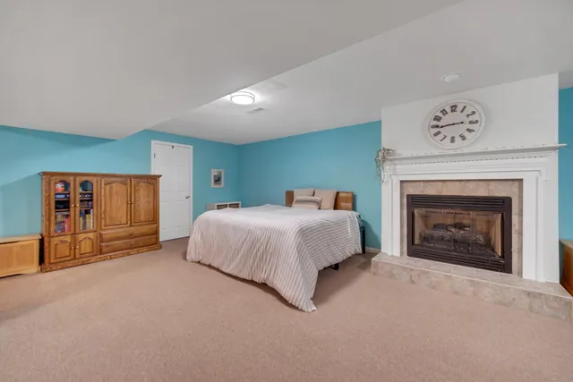 a spacious bedroom with a bed and a fireplace