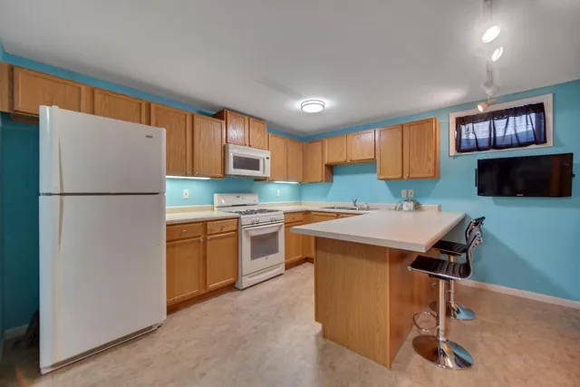 a kitchen with a refrigerator a microwave a sink and a stove