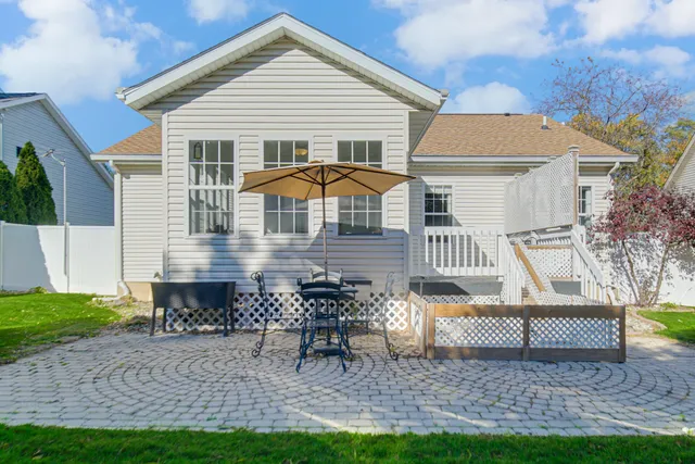 a table and chairs in front of a house