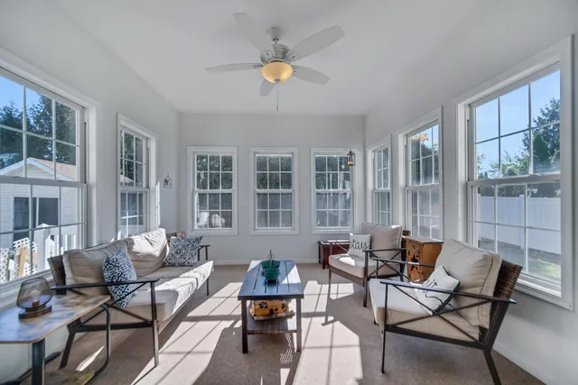 a living room with furniture and a potted plant