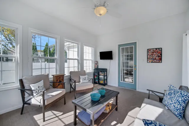 a living room with furniture and a floor to ceiling window