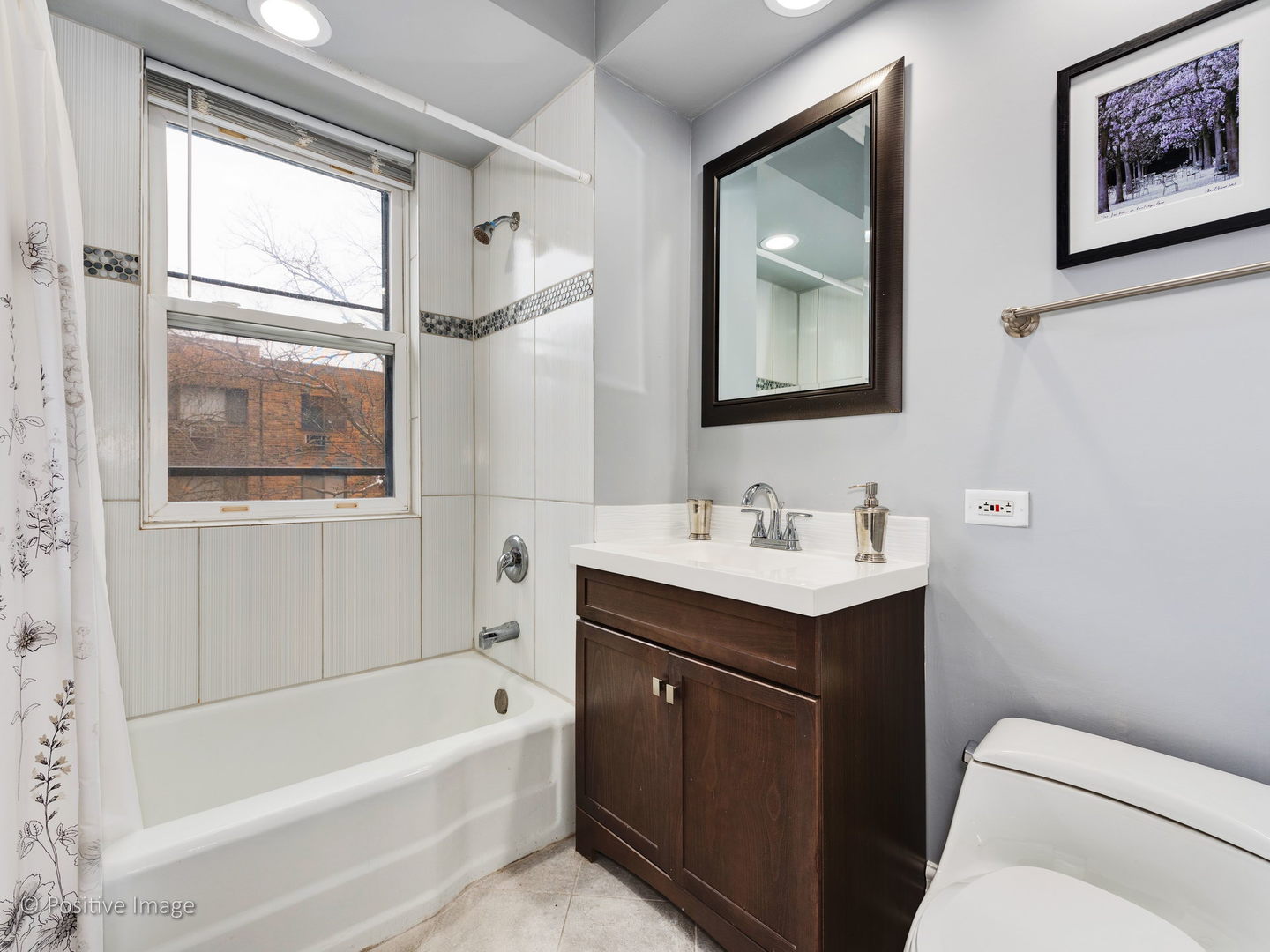 604 West Patterson Avenue, Unit 3A Chicago, IL 60613 - Photo 11 of 11 a bathroom with a toilet sink and mirror
