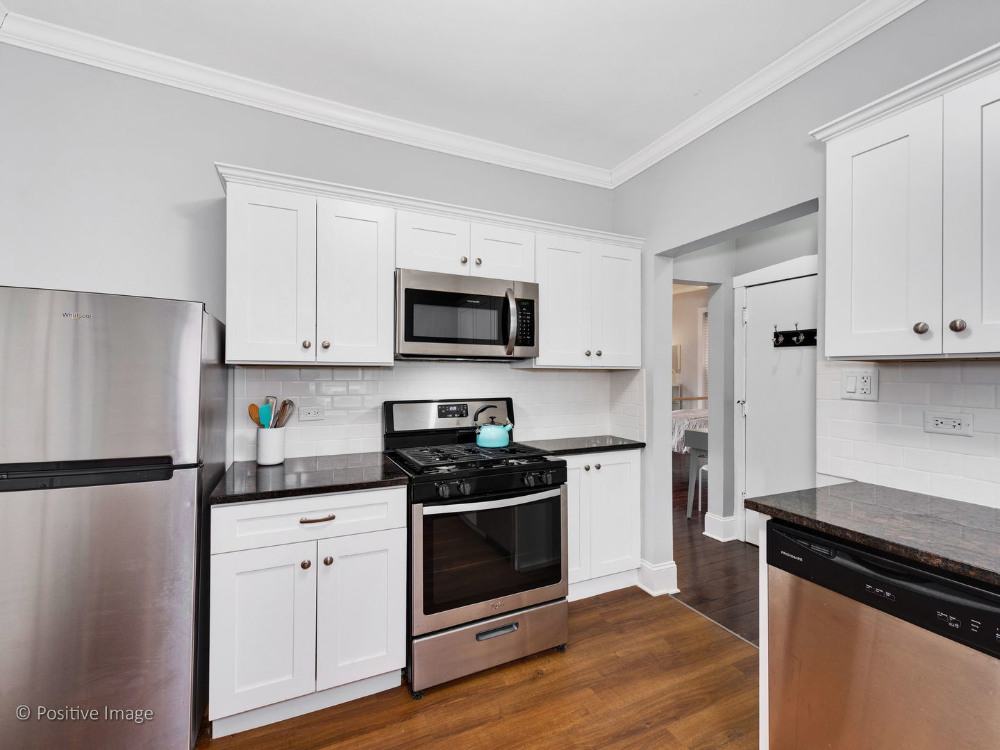 604 West Patterson Avenue, Unit 3A Chicago, IL 60613 - Photo 7 of 11 a kitchen with white cabinets and black appliances