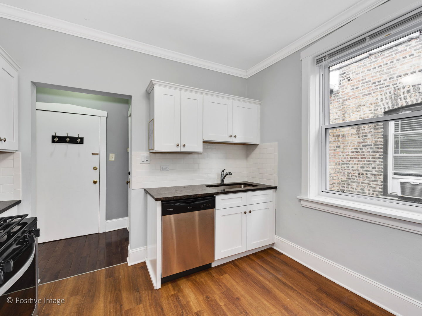 604 West Patterson Avenue, Unit 3A Chicago, IL 60613 - Photo 9 of 11 a kitchen with stainless steel appliances granite countertop a stove and a refrigerator