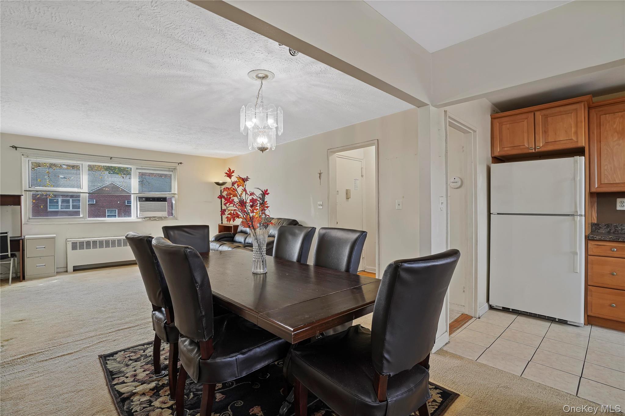 155-27 89th Street, Unit 27 Queens, NY 11414 - Photo 13 of 26 a view of a dining room with furniture and chandelier