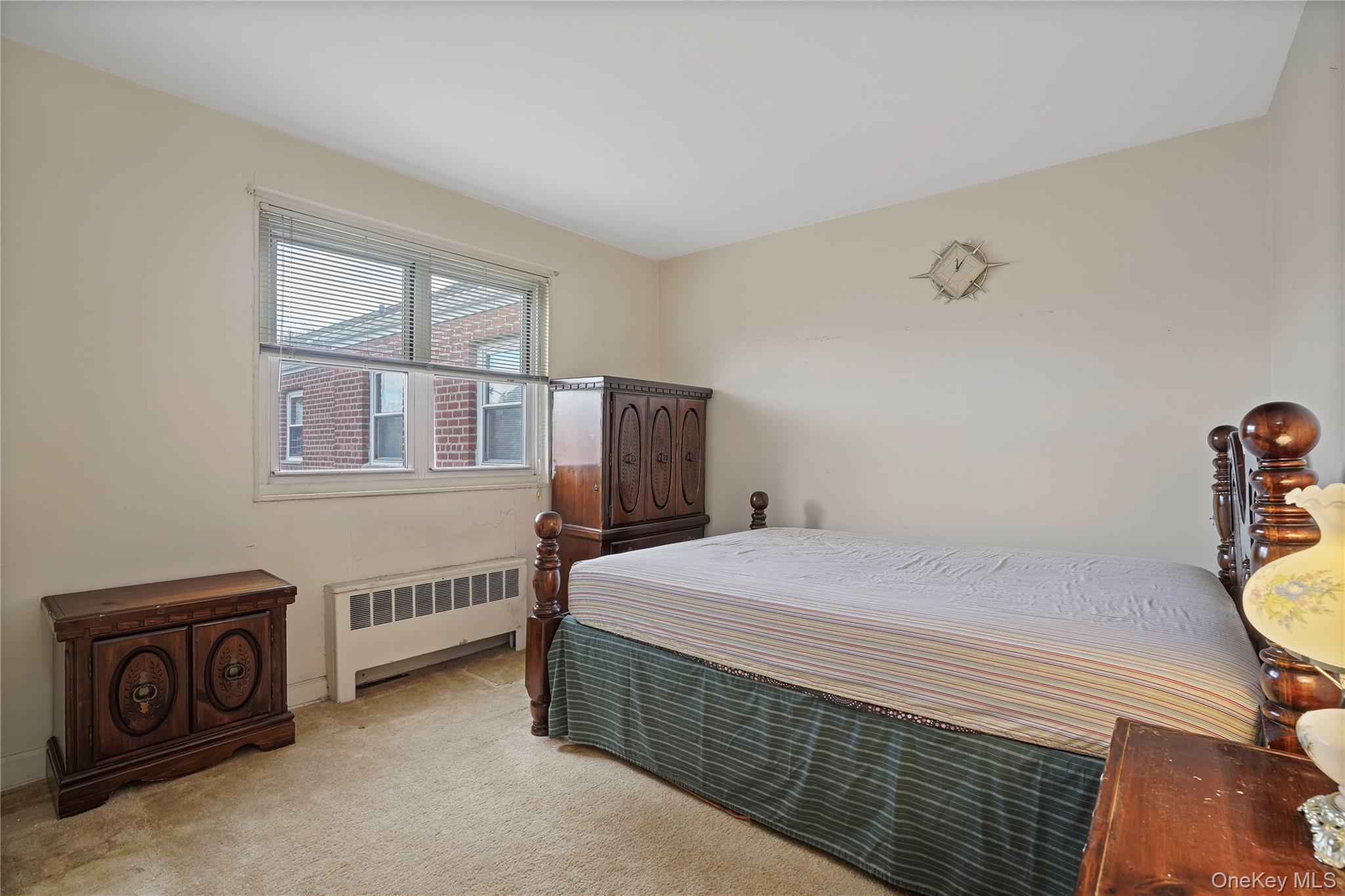 155-27 89th Street, Unit 27 Queens, NY 11414 - Photo 14 of 26 a bedroom with a bed and a table