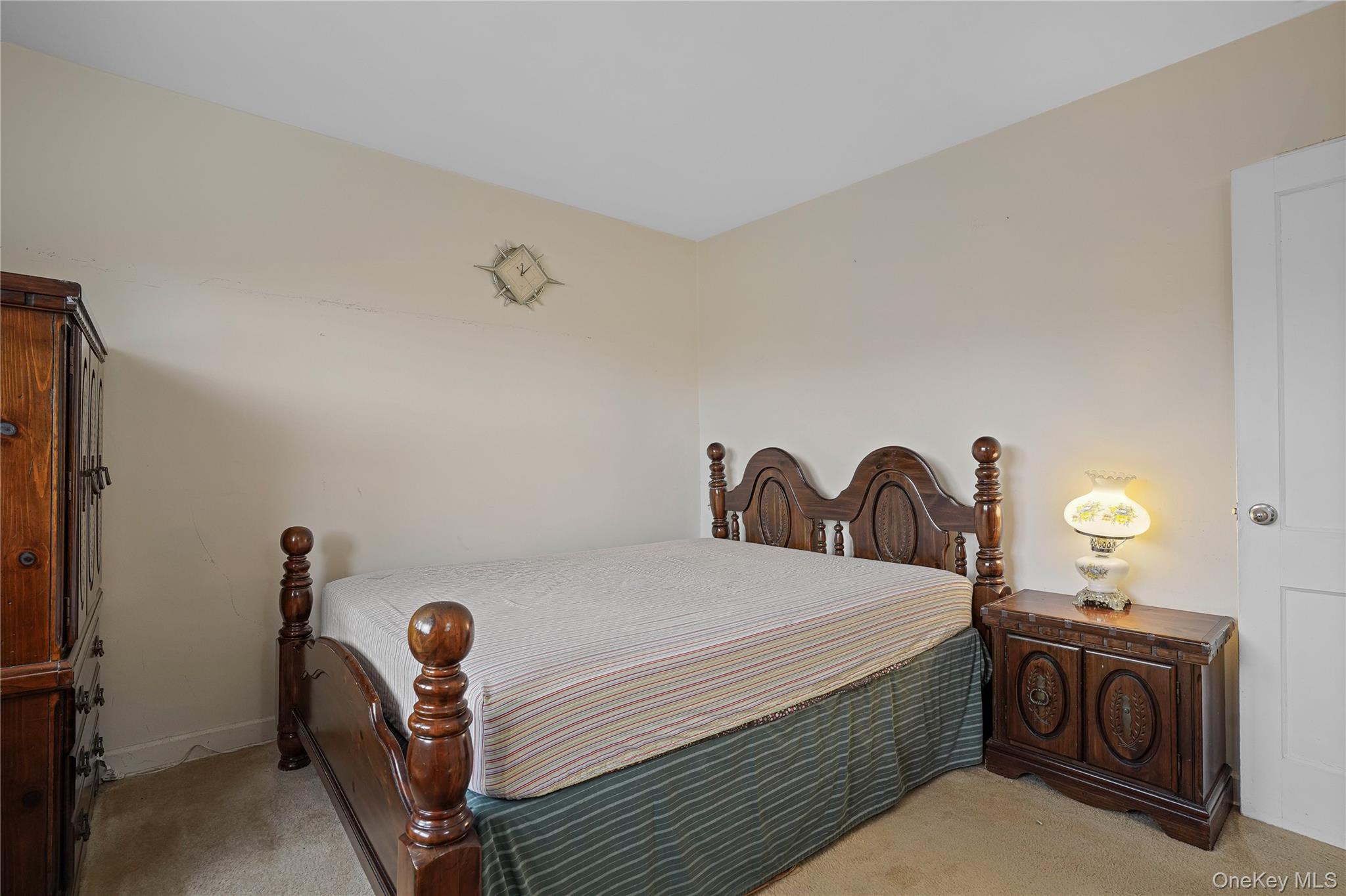 155-27 89th Street, Unit 27 Queens, NY 11414 - Photo 15 of 26 a bedroom with a bed and a chandelier
