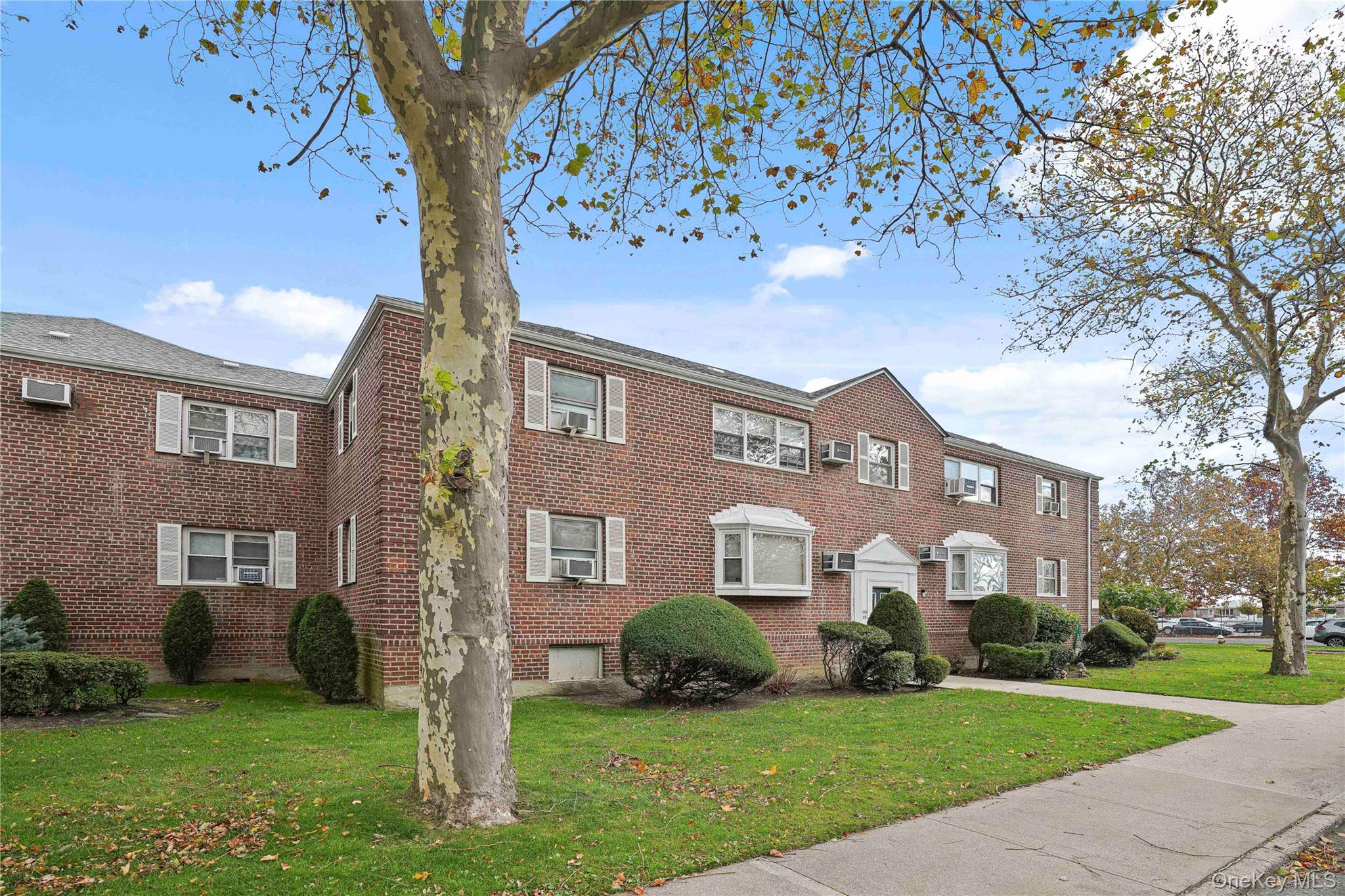 155-27 89th Street, Unit 27 Queens, NY 11414 - Photo 23 of 26 a front view of a house with a yard