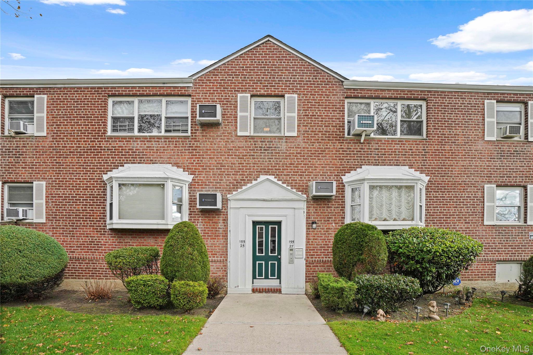 155-27 89th Street, Unit 27 Queens, NY 11414 - Photo 24 of 26 a view of a brick house with a yard plants and large tree