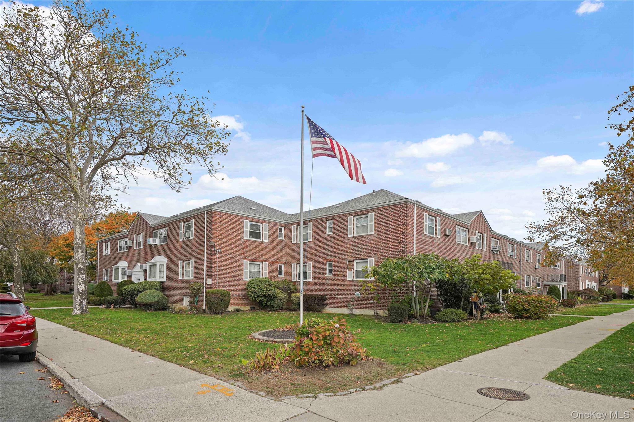 155-27 89th Street, Unit 27 Queens, NY 11414 - Photo 25 of 26 a front view of a house with a garden