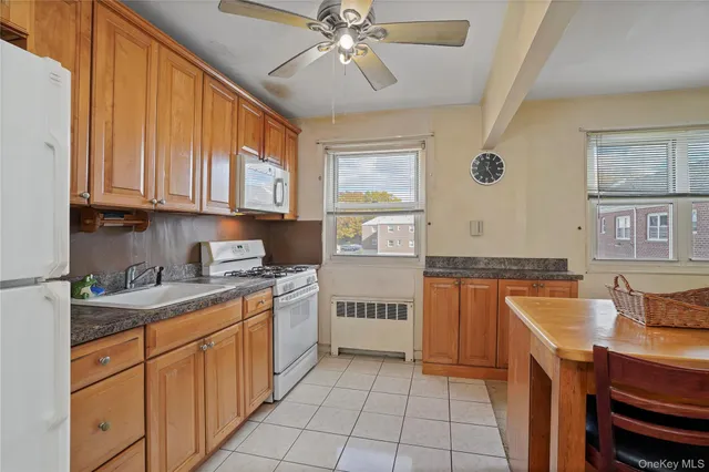a kitchen with stainless steel appliances granite countertop a stove sink and cabinets