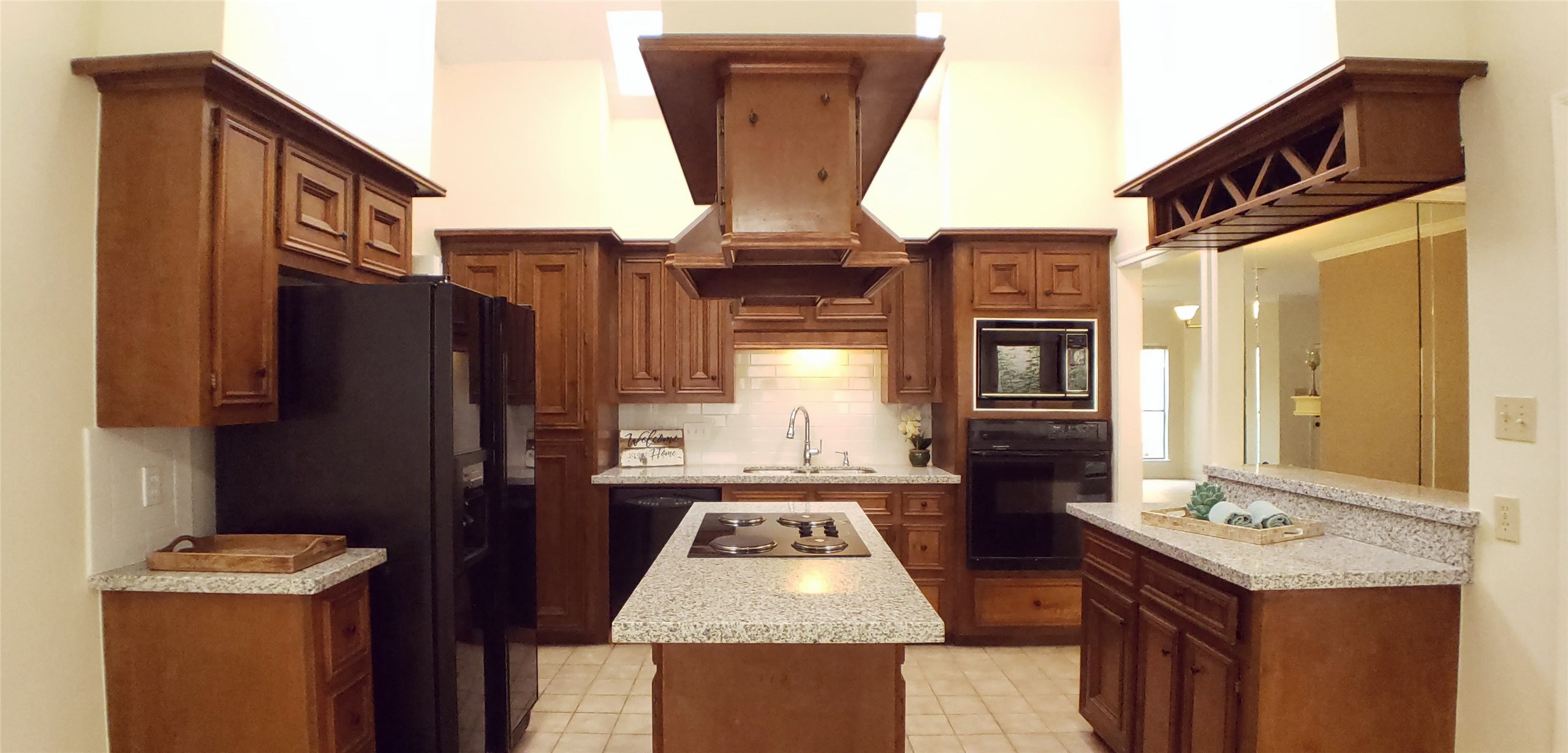 6607 Tournament Drive Houston, TX 77069 - Photo 9 of 46 a bathroom with a granite countertop sink a refrigerator and a stove