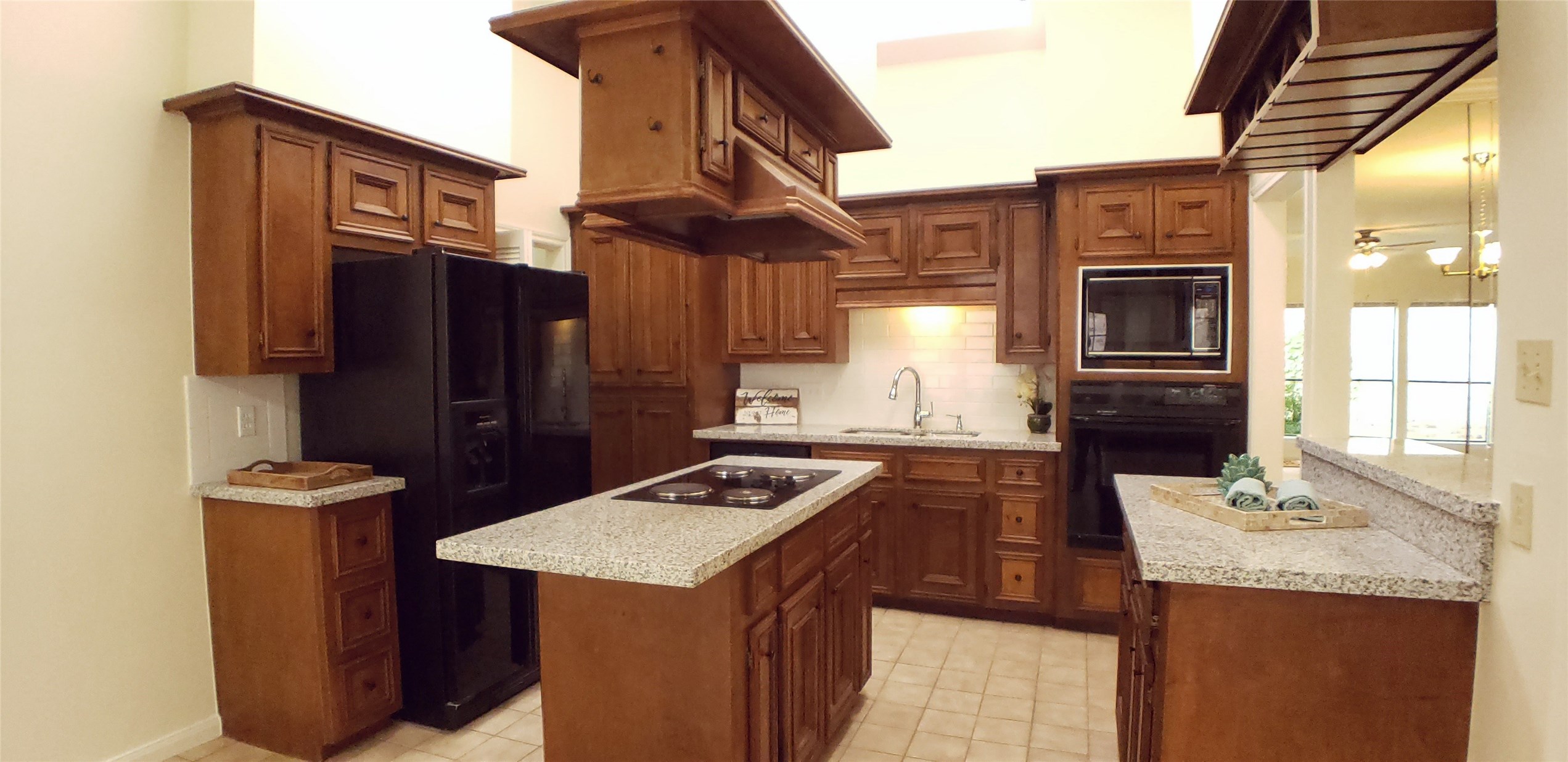 6607 Tournament Drive Houston, TX 77069 - Photo 10 of 46 a kitchen with granite countertop a sink a stove and refrigerator