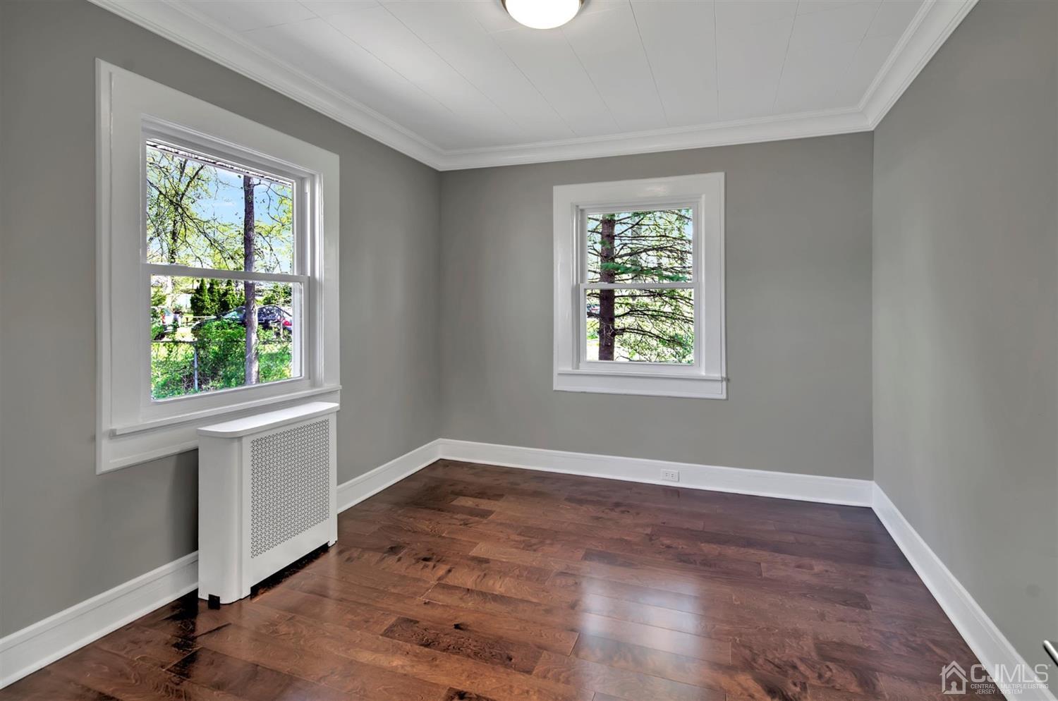 80 North Hill Road Colonia, NJ 07067 - Photo 13 of 23 an empty room with wooden floor and windows