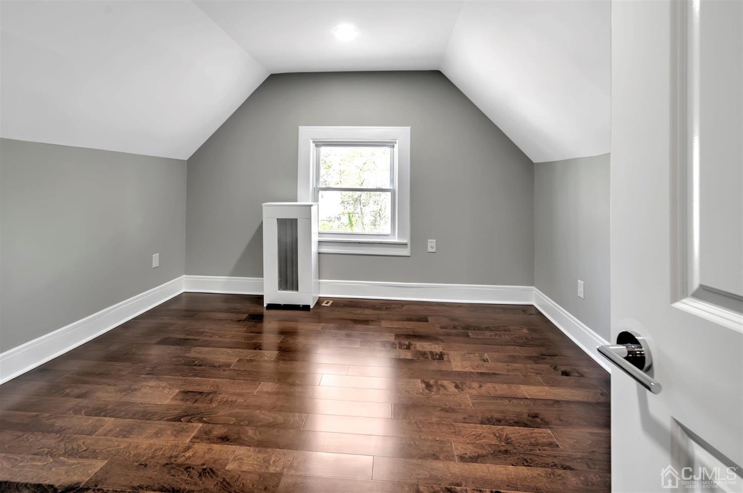 80 North Hill Road Colonia, NJ 07067 - Photo 15 of 23 an empty room with wooden floor and windows