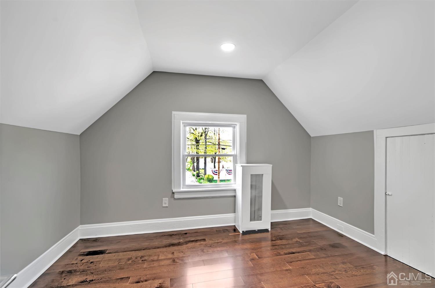 80 North Hill Road Colonia, NJ 07067 - Photo 17 of 23 an empty room with wooden floor and windows