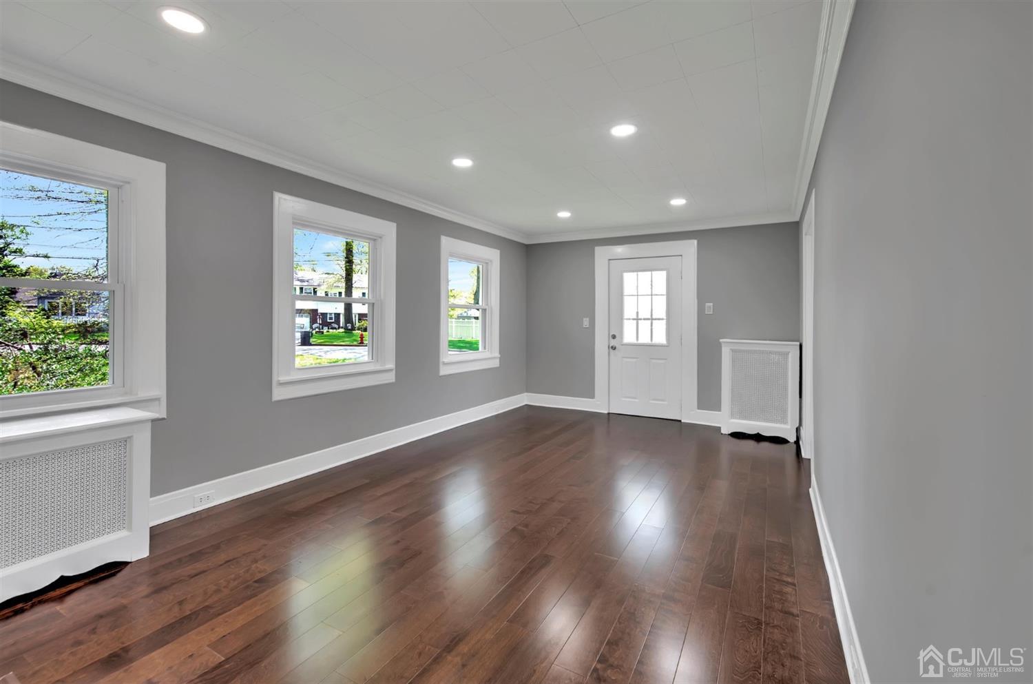 80 North Hill Road Colonia, NJ 07067 - Photo 5 of 23 an empty room with wooden floor and windows