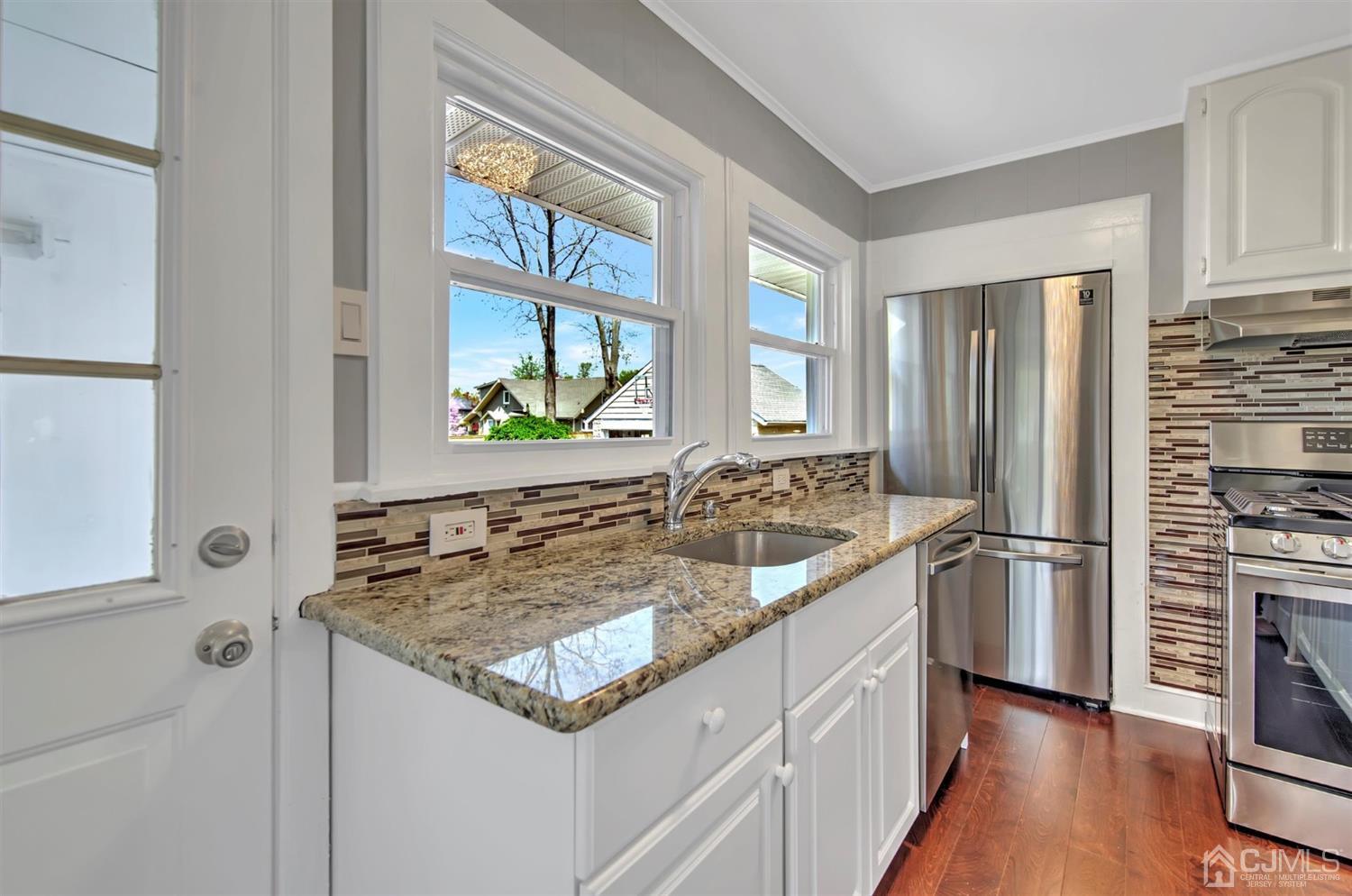 80 North Hill Road Colonia, NJ 07067 - Photo 7 of 23 a kitchen with a stove a sink and a refrigerator
