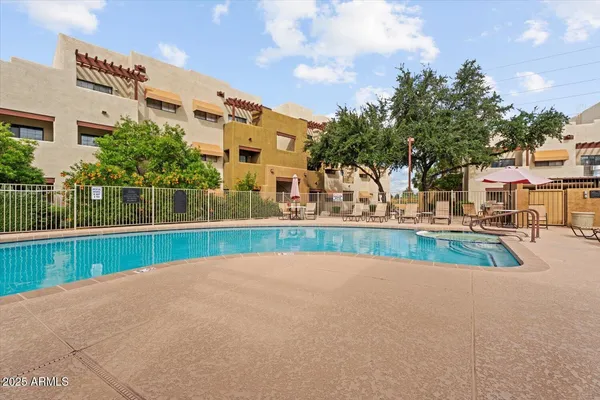 a view of yard with swimming pool and tall trees