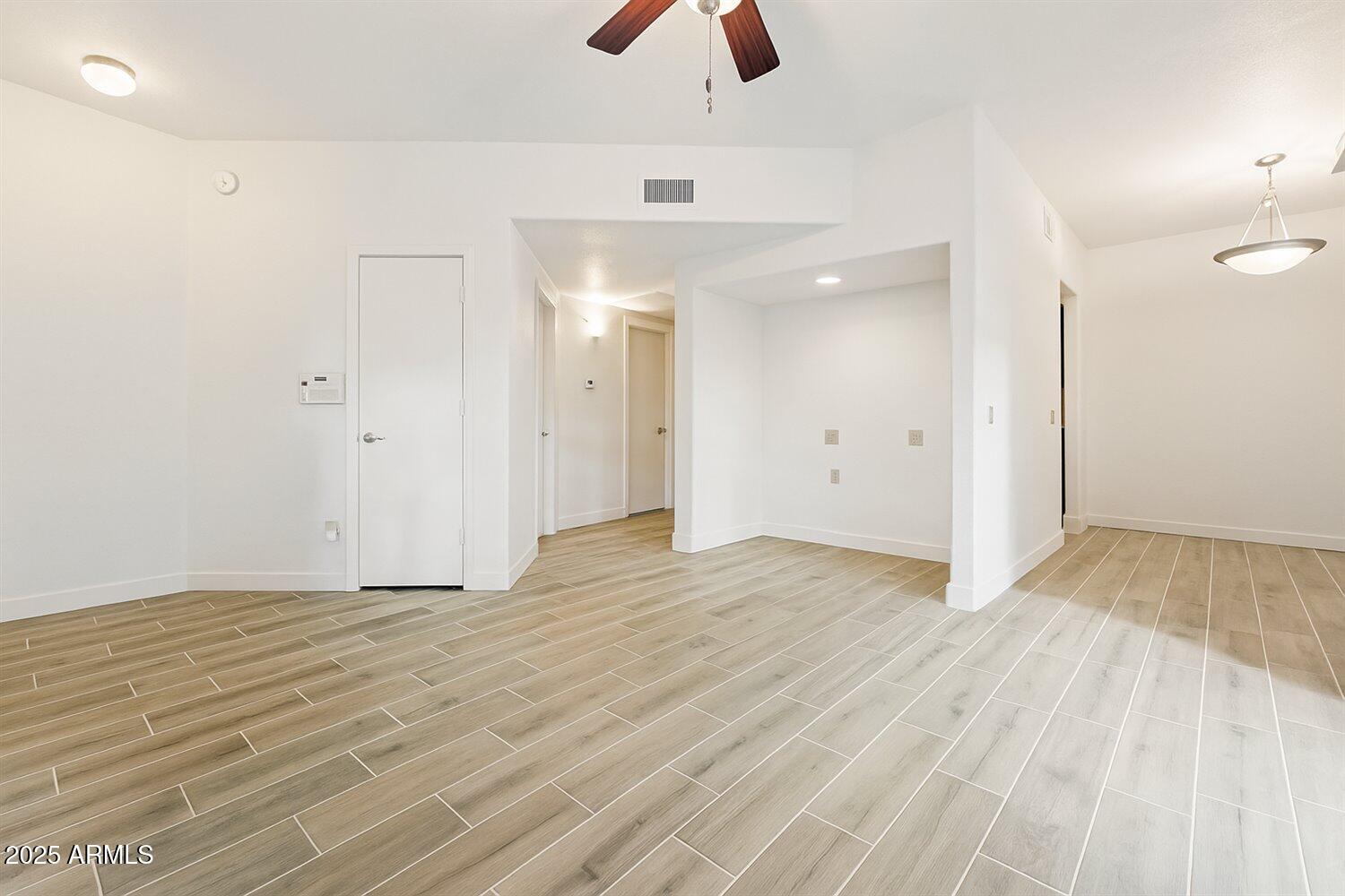 3434 East Baseline Road, Unit 260 Phoenix, AZ 85042 - Photo 4 of 15 a view of an empty room with wooden floor