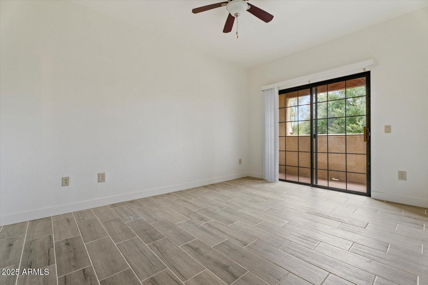 3434 East Baseline Road, Unit 260 Phoenix, AZ 85042 - Photo 8 of 15 wooden floor in an empty room with a window