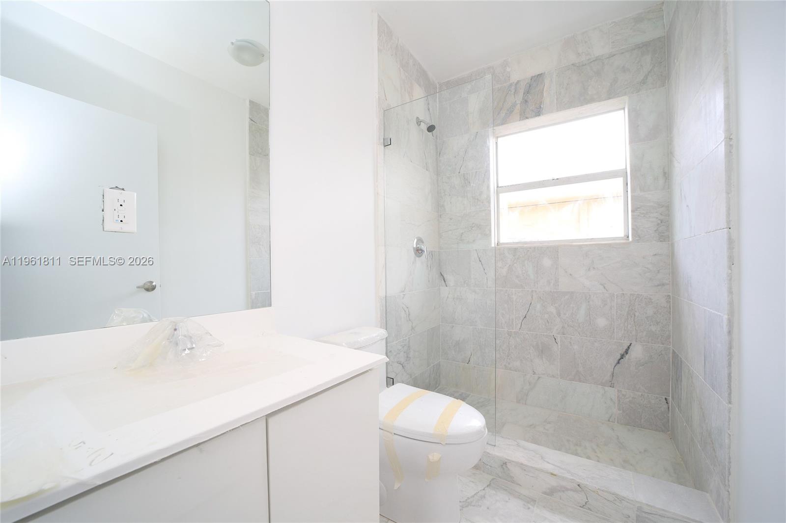 810 7th Street, Unit 104 Miami Beach, FL 33139 - Photo 11 of 11 a bathroom with a sink a toilet and shower