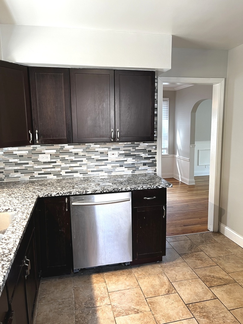 17107 Longfellow Avenue Hazel Crest, IL 60429 - Photo 16 of 21 a kitchen with granite countertop a stove and cabinets