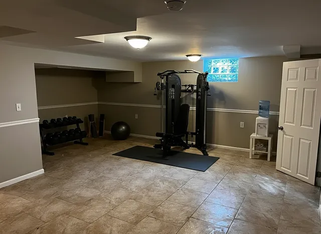 a room with gym equipment and white walls
