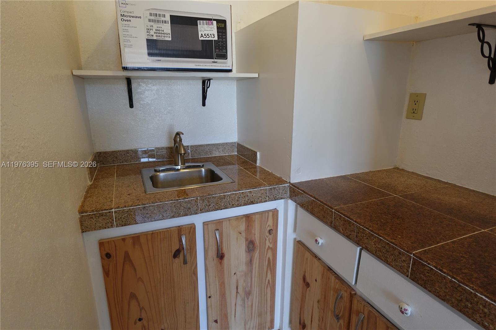 11262 Southwest 74th Street Miami, FL 33173 - Photo 14 of 19 a kitchen with a sink and cabinets