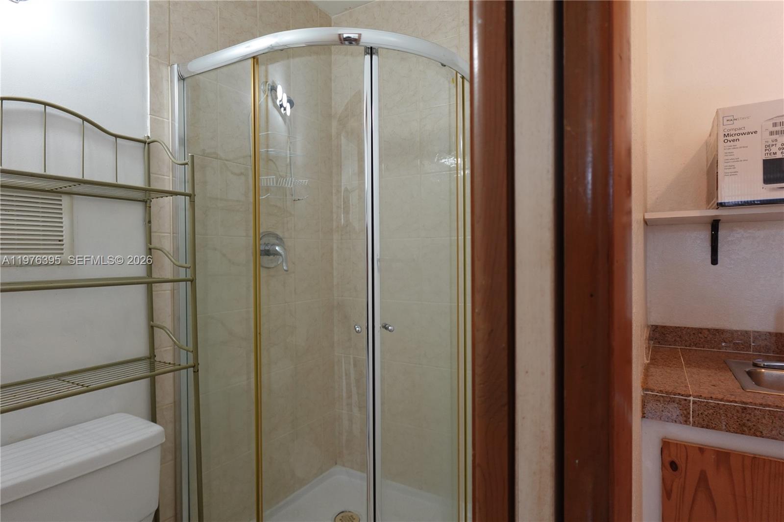 11262 Southwest 74th Street Miami, FL 33173 - Photo 17 of 19 a bathroom with a shower a toilet and a sink